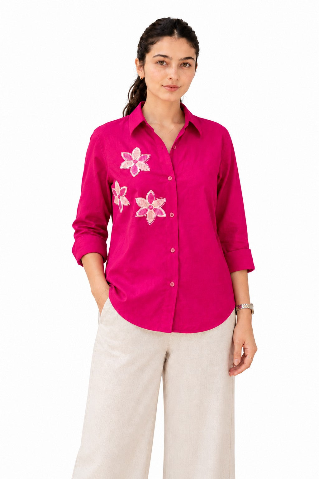 Vibrant fuchsia shirt adorned with delicate floral appliqué detailing across the chest