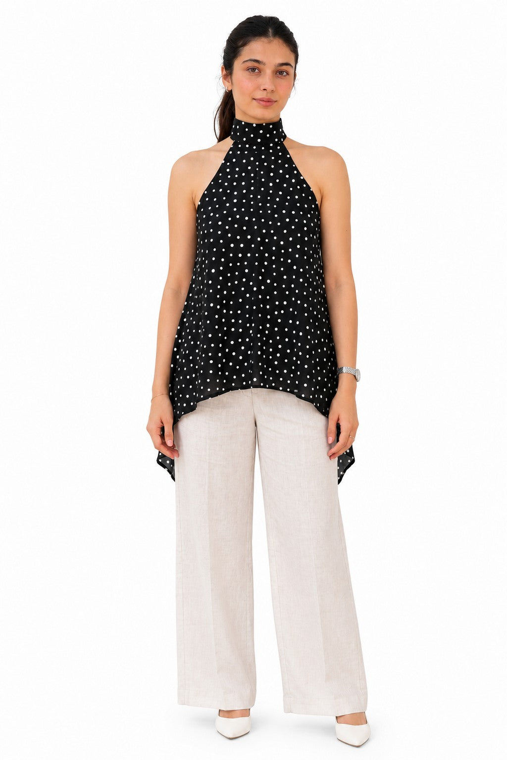 Chic black halter top featuring an elegant high neckline and playful all-over white polka dots.
