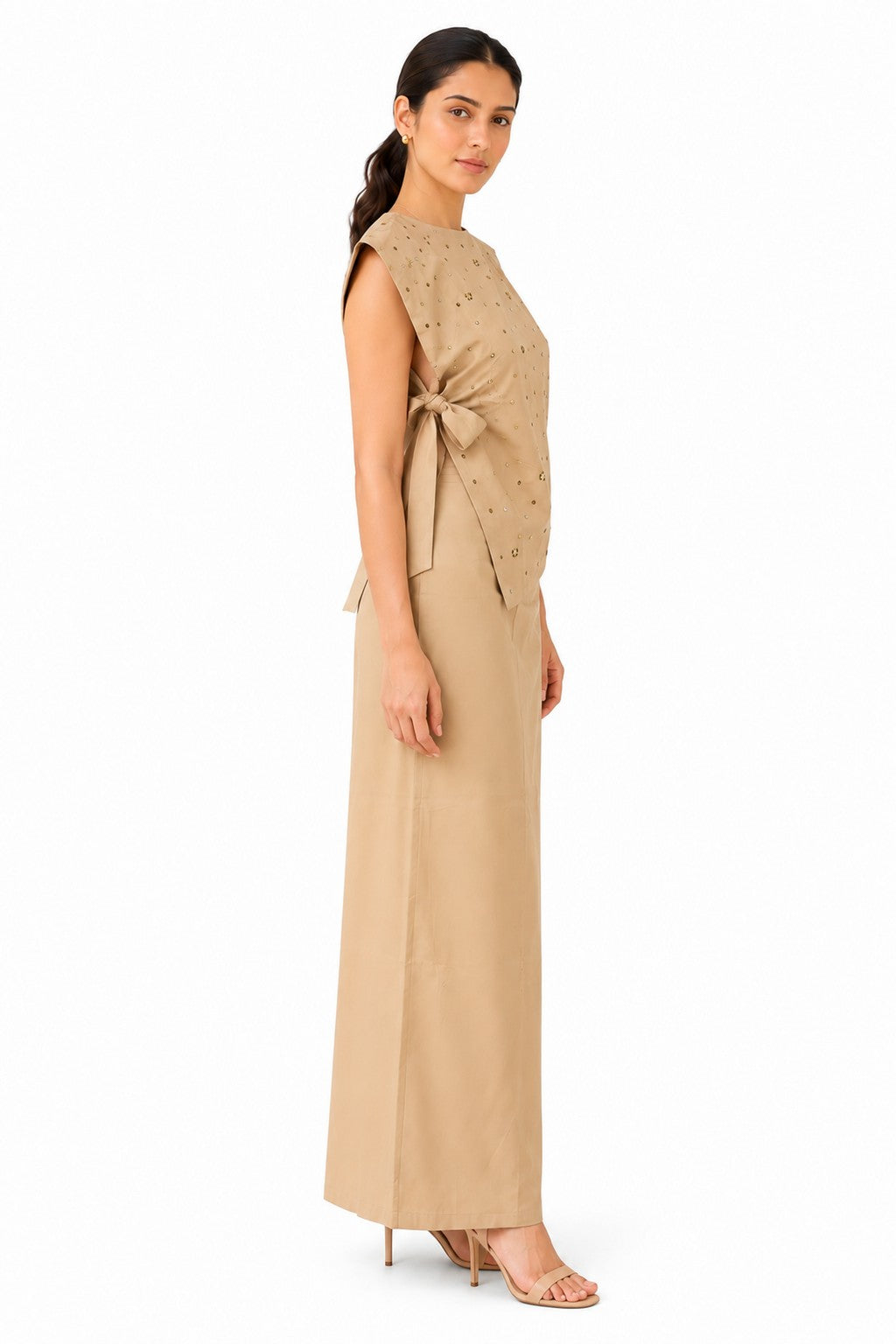 Asymmetrical wrap-style silhouette with layered draping and a softly fitted shape that flows into a sleek maxi skirt.