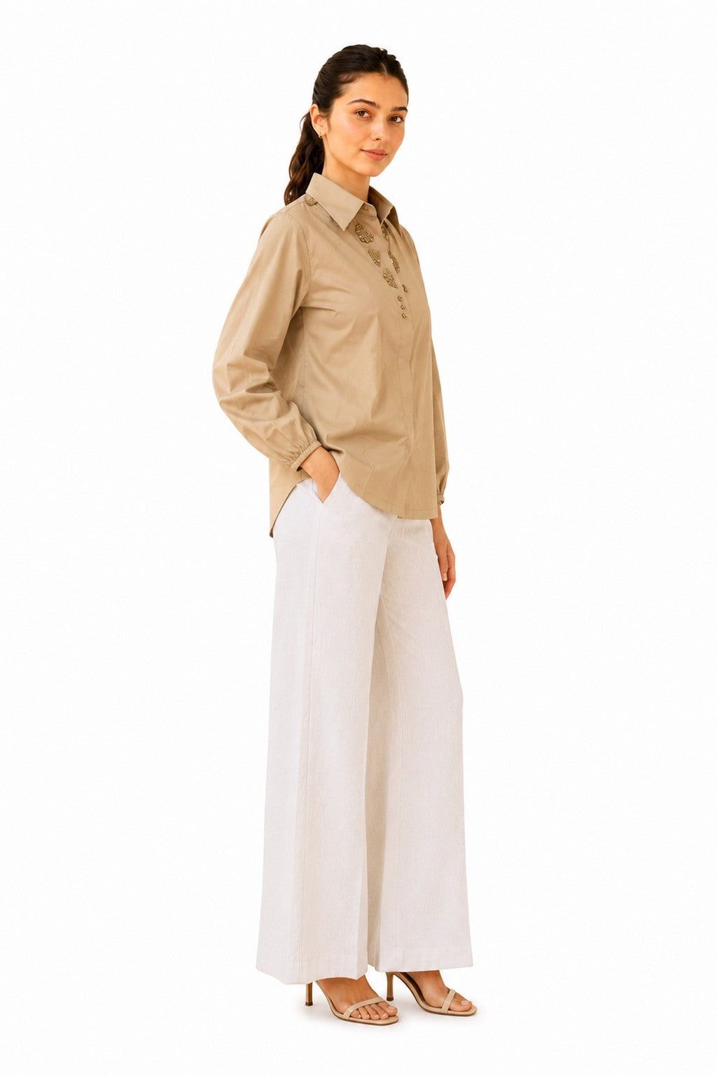 Relaxed silhouette with softly gathered sleeves and a clean, flattering curved hem.