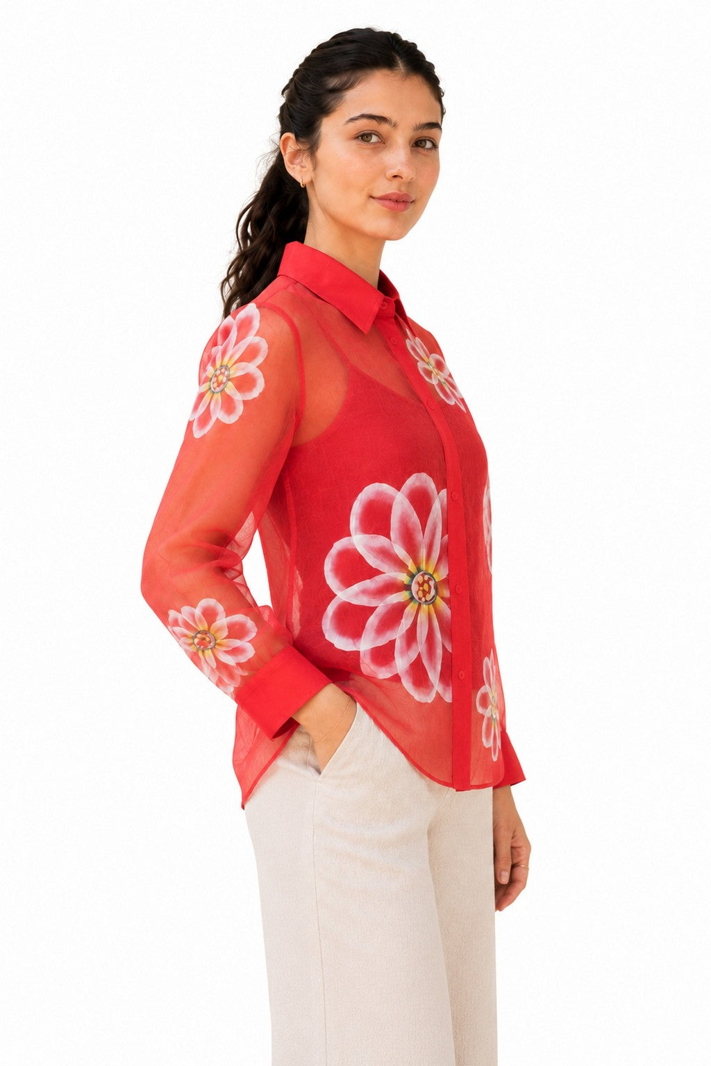 Relaxed silhouette with translucent long sleeves, floral detailing, and softly rounded hem for an effortless drape.