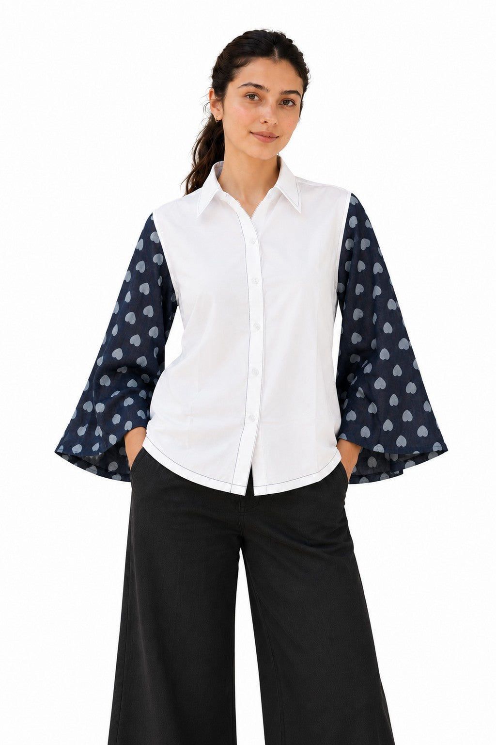 Crisp white shirt featuring dramatic navy sheer bell sleeves adorned with a playful heart print.