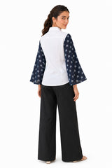 Clean white back with the same fluid bell-sleeve design, creating a balanced contrast with the patterned sleeves.