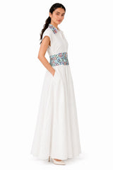Flowing A-line silhouette with a defined embroidered waist panel