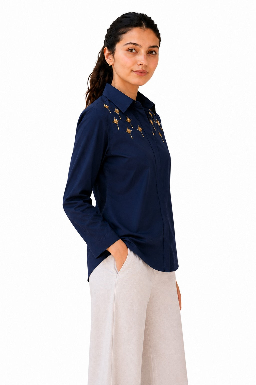 Relaxed straight silhouette with long sleeves and delicate gold detailing extending subtly toward the shoulder.