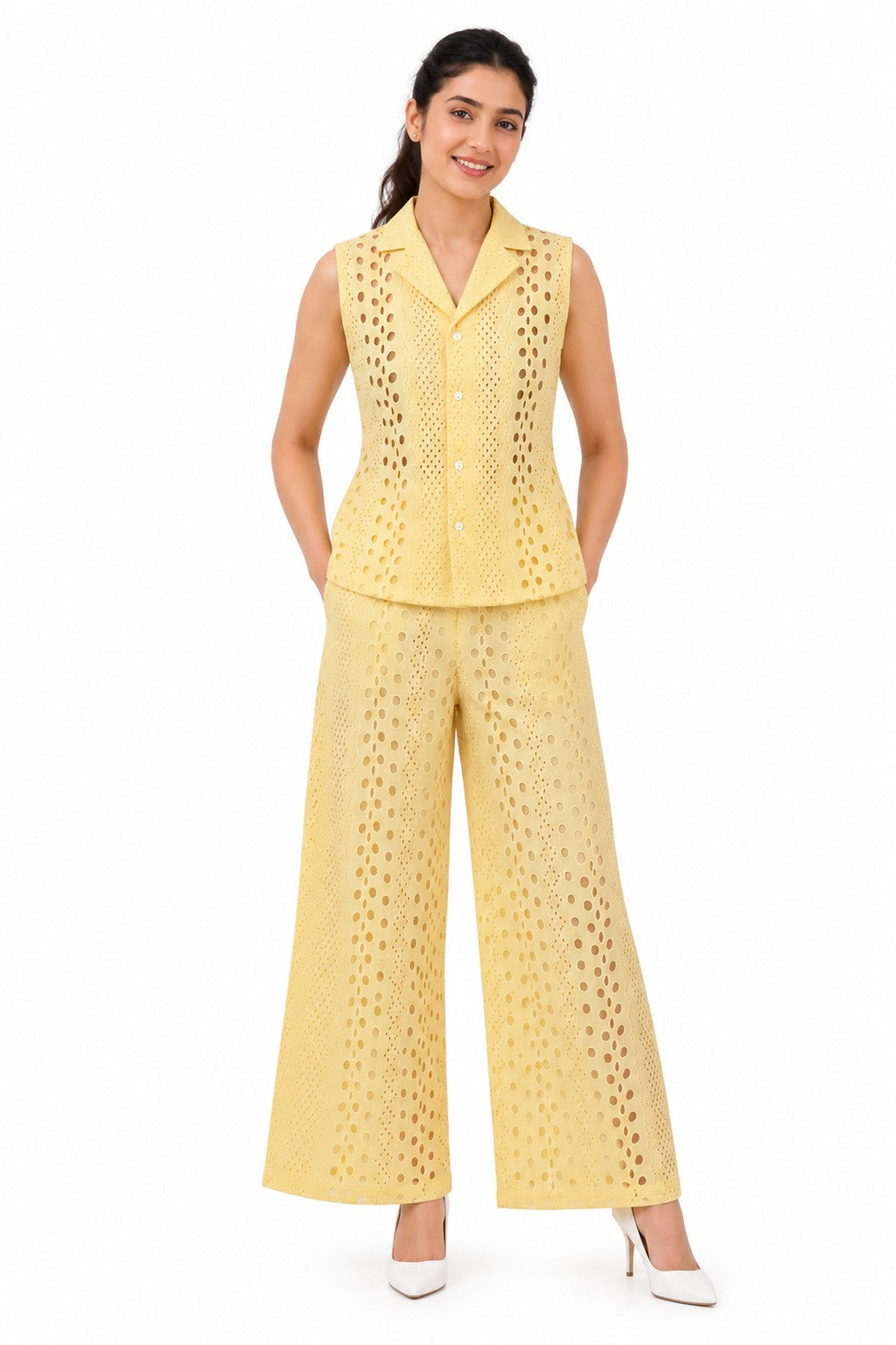 Soft yellow sleeveless collared vest with button closure and intricate circular cutwork