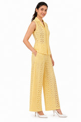 Tailored waistline and relaxed wide-leg silhouette highlight the delicate cutwork texture