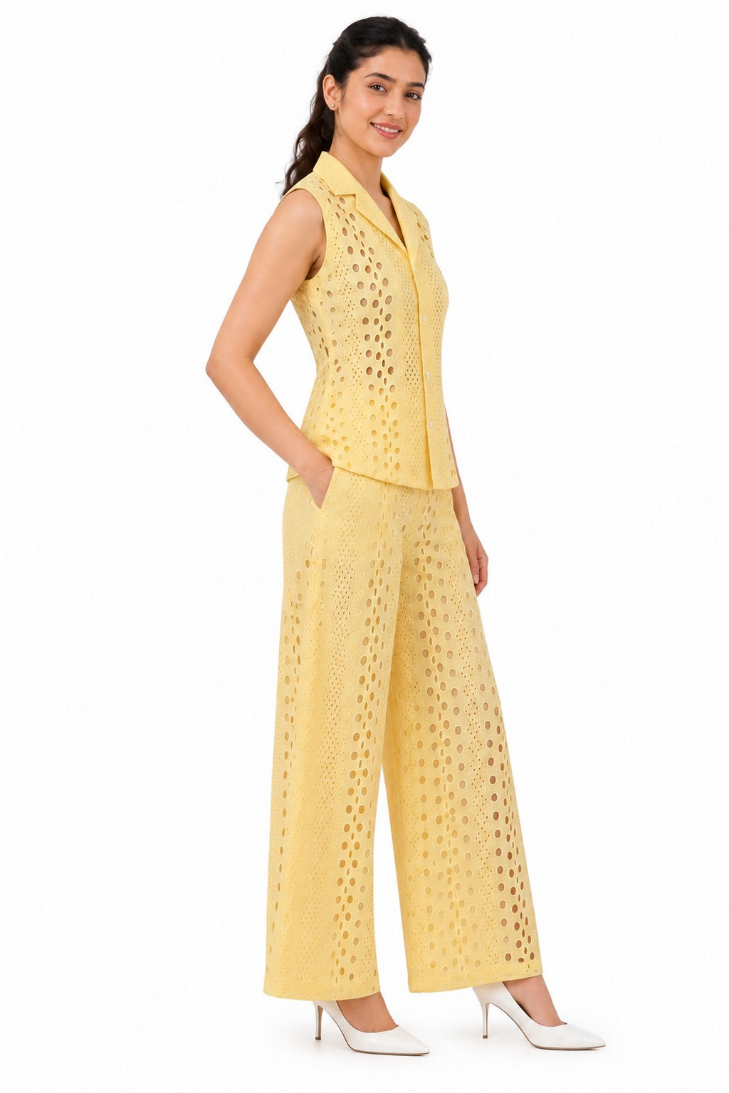 Tailored waistline and relaxed wide-leg silhouette highlight the delicate cutwork texture
