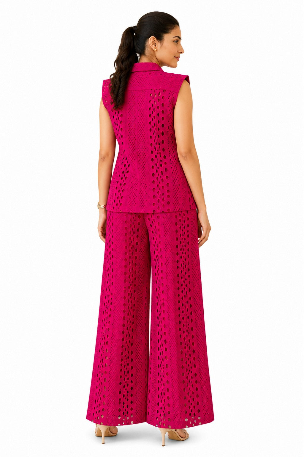 Clean cutwork vest with a structured back and matching wide-leg trousers, showcasing the intricate laser-cut texture throughout.