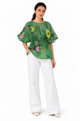 Fresh green floral top featuring a sheer finish, vibrant botanical print, and a softly gathered waist for a flattering silhouette.