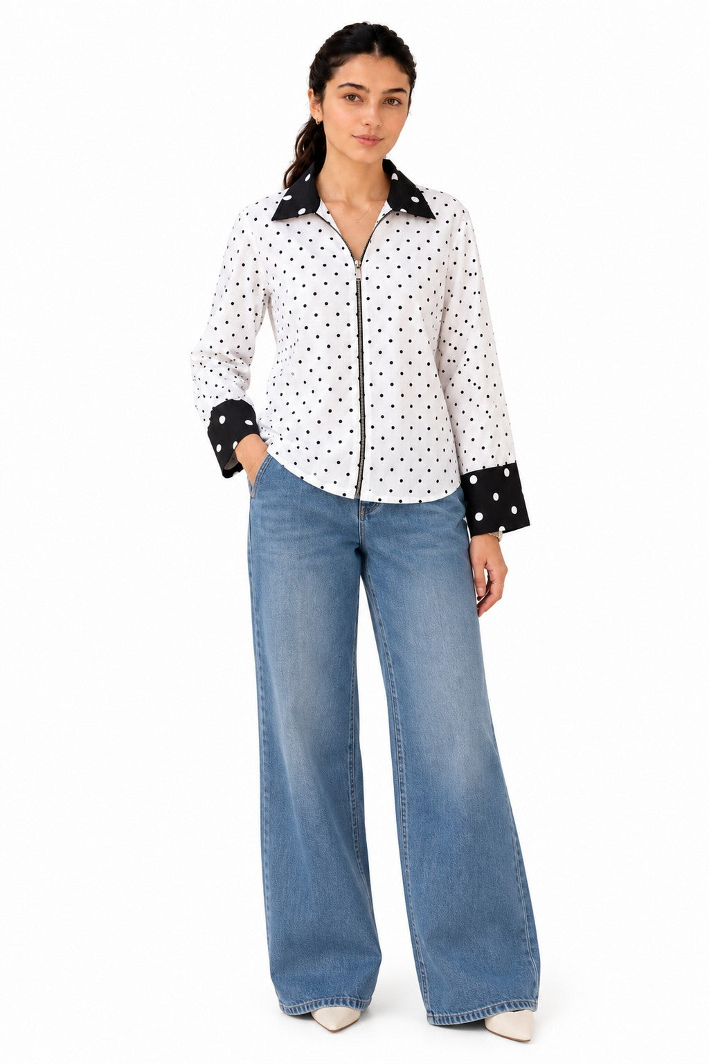 Chic monochrome shirt featuring a white polka-dot body, contrasting black collar and cuffs, and a sleek front zip closure.
