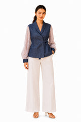 Chic navy wrap-style top with a structured shawl collar, waist tie, and contrasting sheer lace sleeves with matching cuffs.