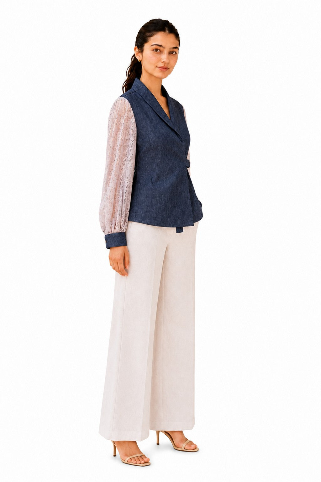 Tailored wrap silhouette with a defined waist, softly voluminous lace sleeves, and a gently flared hem.