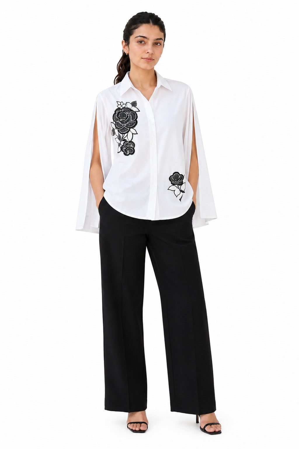 Crisp white shirt featuring bold black floral embroidery, a classic collar, button-down front, and dramatic open-cut sleeves.