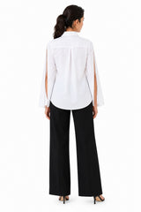 Clean white back with a softly relaxed fit, flowing open sleeves, and a minimal finish.