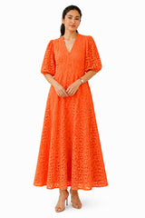 Vibrant orange midi dress featuring a flattering V-neckline, sculpted waist, puff sleeves, and intricate all-over cutwork detailing.