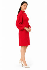 Sleek mini silhouette with softly gathered sleeves and a structured fit that highlights the dress’s textured finish.