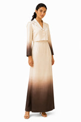 Elegant ivory cropped blazer with a notched collar, double-button closure, tailored fit, and dramatic ombré sleeves paired with a flowing gradient skirt.