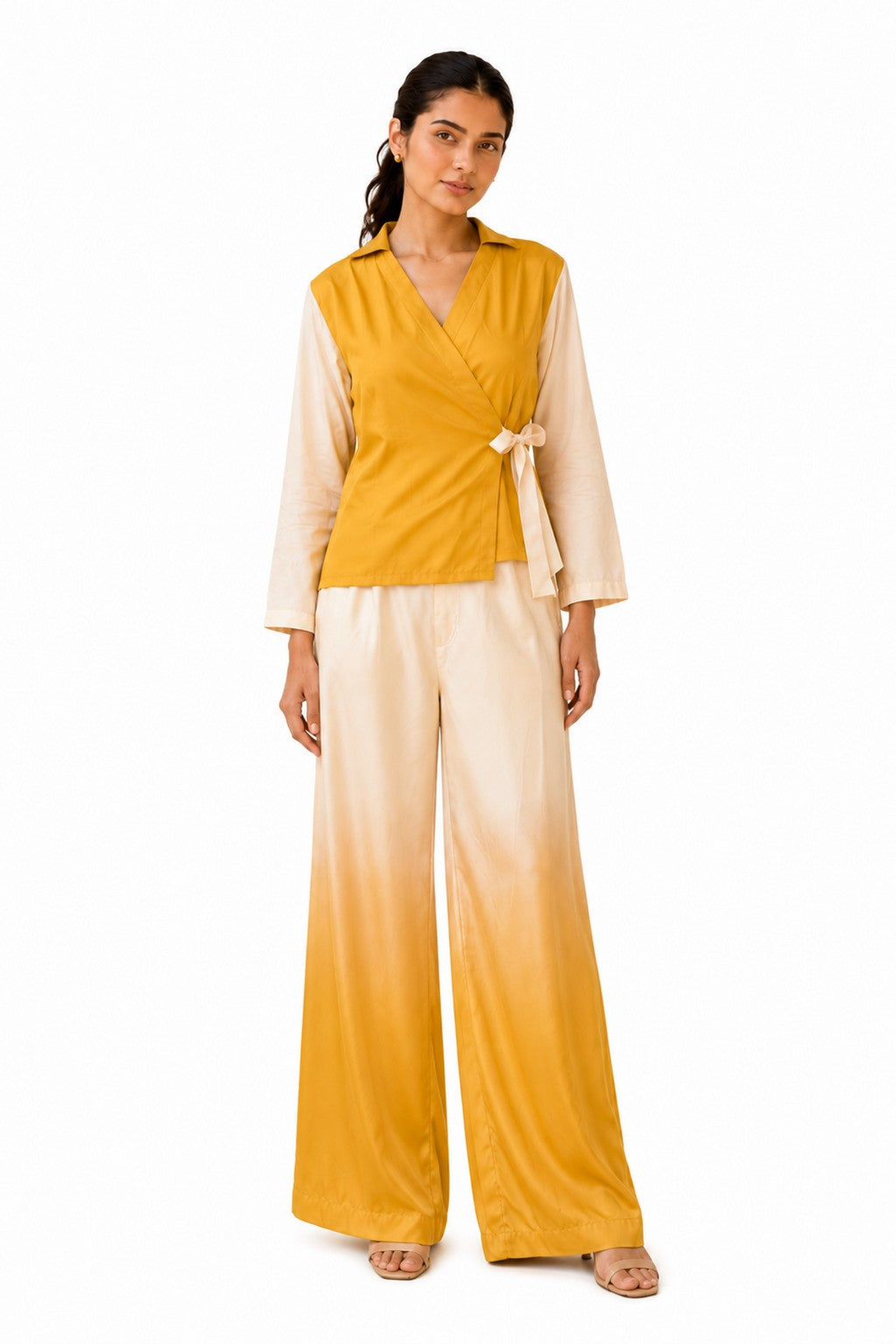 Mustard-yellow wrap-style top with a collared neckline, contrasting sheer long sleeves, and an elegant side bow tie.
